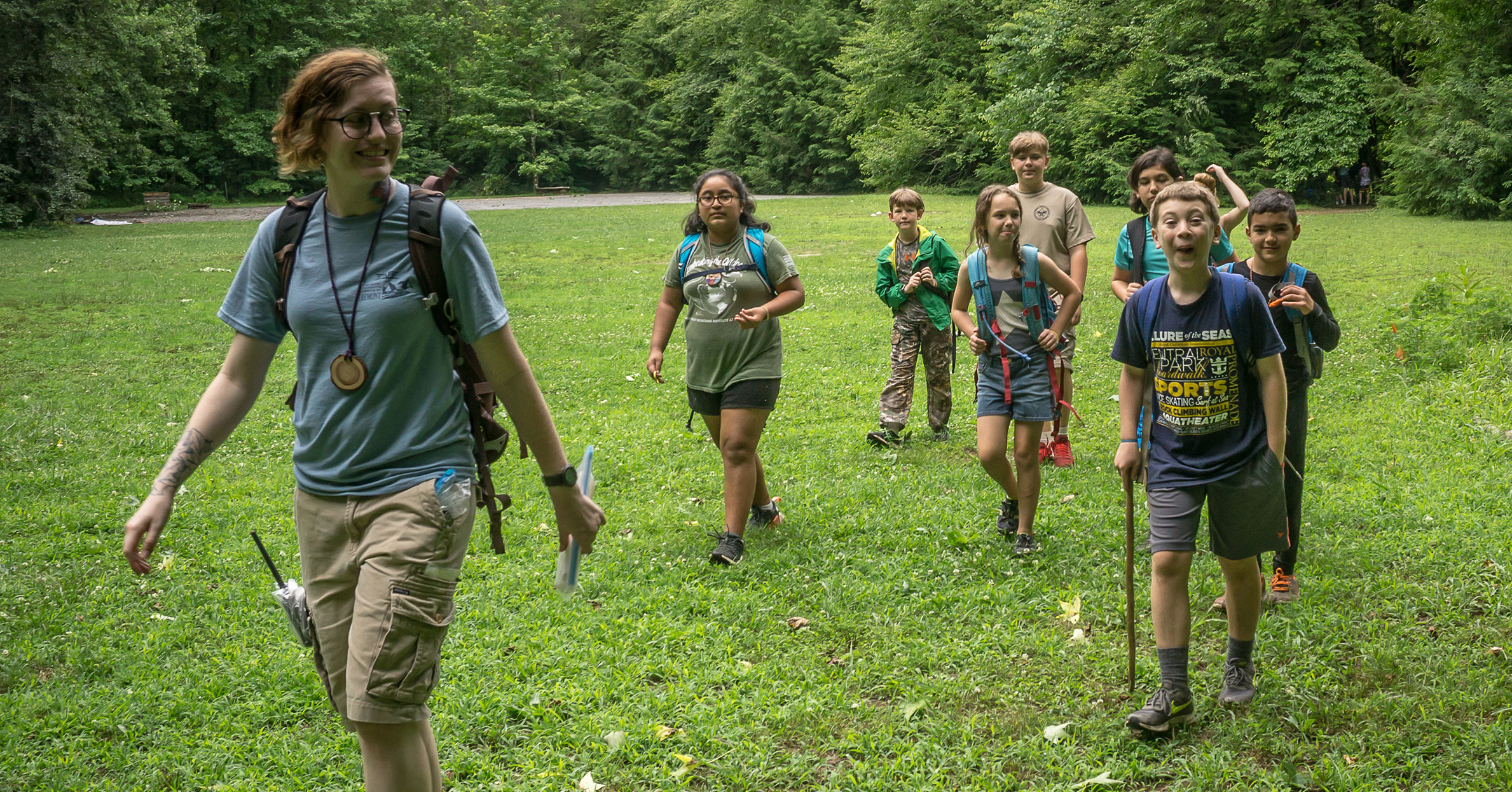 A teacher naturalist leads a group of summer campers