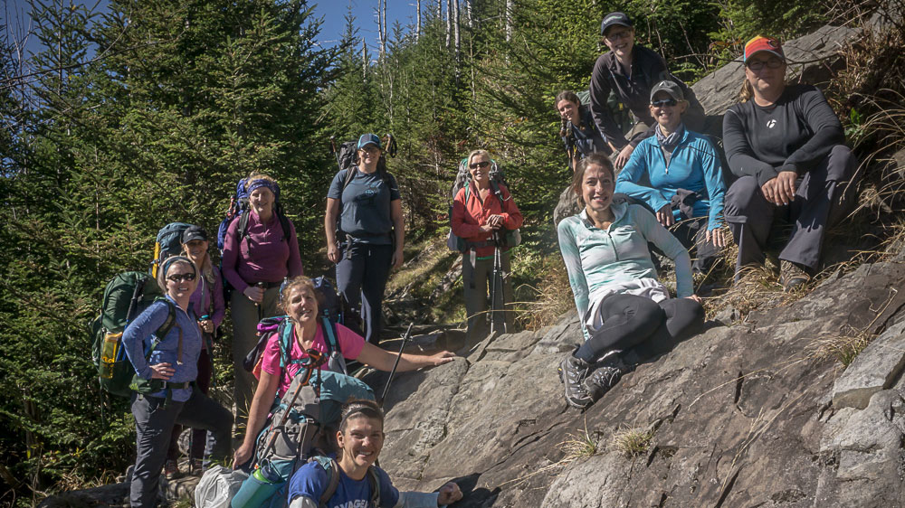 A group of women backpackers pause along a mountainside in Great Smoky Mountains National Park