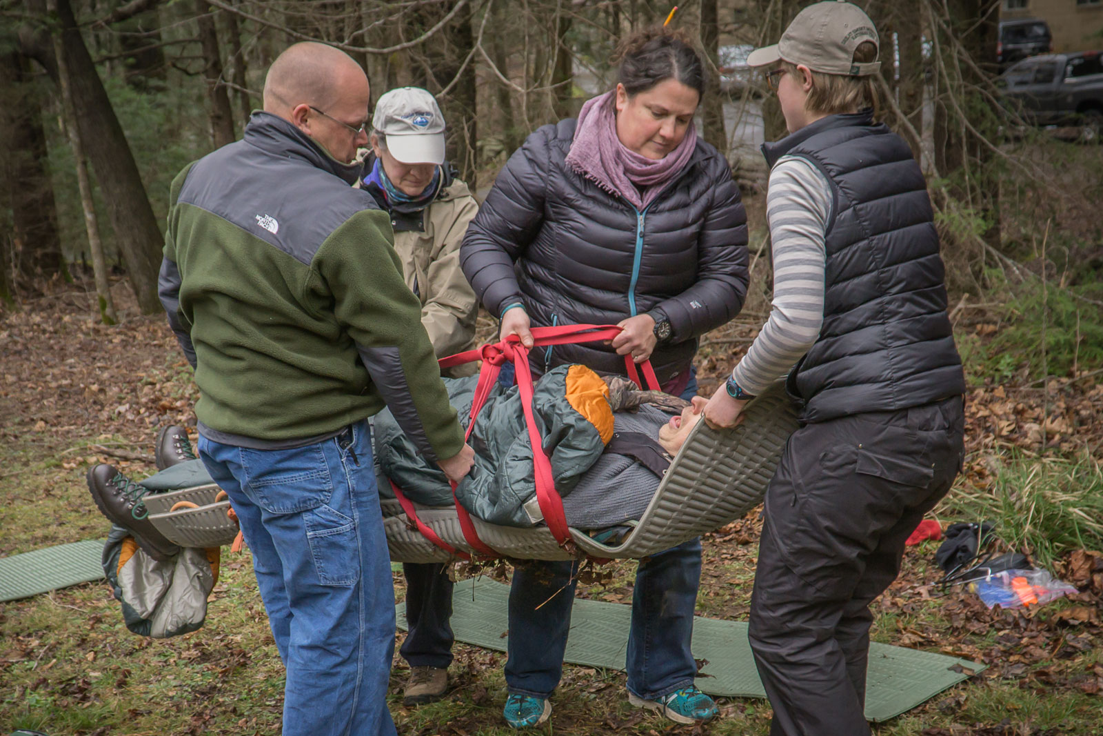 Participants in the Wilderness Emergency Medical Responder course practice carrying an injured person