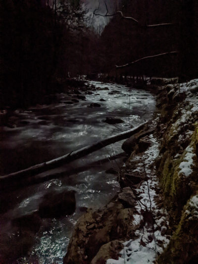 The Middle Prong river at night with snow on the ground